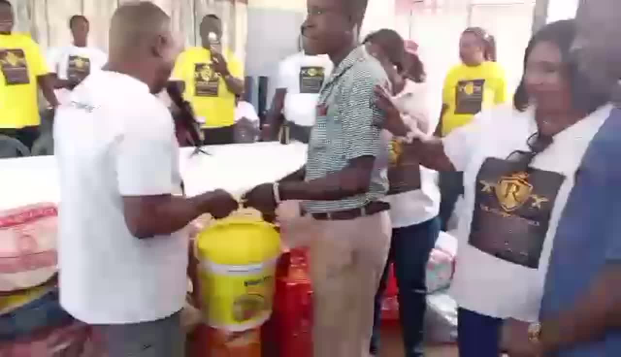 Perfect Royals members presenting donated provisions during a community visit